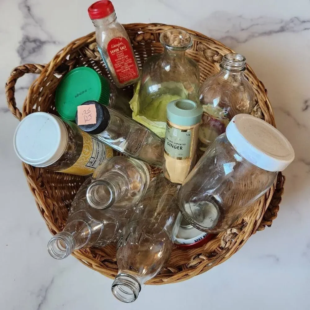 Woven wicker round basket handles various clear glass bottles vintage spice pine